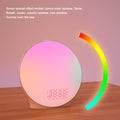 Round LED lamp with colorful display on a wooden surface